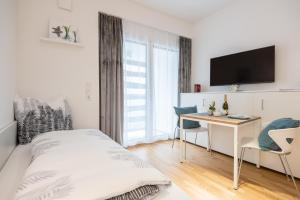 Μια τηλεόραση ή/και κέντρο ψυχαγωγίας στο Serviced Apartment München-Messe/G