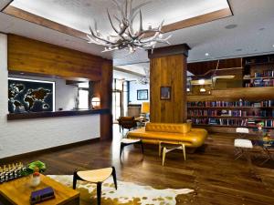 a living room with a couch and a library at Gild Hall, A Thompson Hotel, by Hyatt in New York