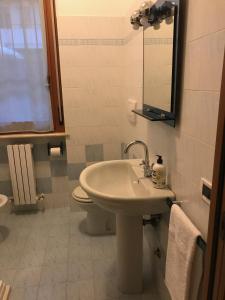 a bathroom with a sink and a toilet and a mirror at Casavacanze estate 1 in San Benedetto del Tronto
