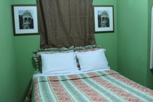 
A bed or beds in a room at La Maison Hotel
