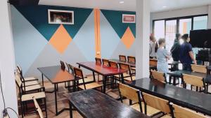 a room with tables and chairs and people standing in it at ดาธชา ลอฟท์วิว in Seka