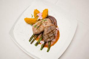 a plate of food with meat and asparagus at Hotel Parador de Alcalá in Oaxaca City +64 photos