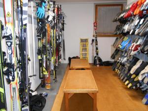 a room filled with lots of skis on the wall at Chalet Hotel Diamant in San Martino in Badia