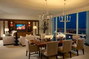 a dining room with a table and chairs and a large window at Trump International Hotel Las Vegas in Las Vegas