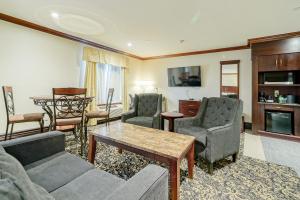 a living room with a couch and chairs and a table at Woodbine Hotel & Suites in Toronto