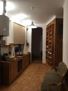 a kitchen with wooden floors and a kitchen with a table at klusums in Liepāja