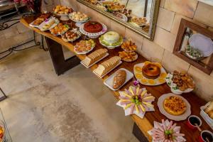 a long table filled with different types of food at Pousada Solar da Imperatriz in Tiradentes