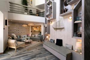 a living room with two couches and a table at Sandcastle Hotel on the Beach in Pismo Beach