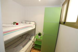 a small bedroom with green cabinets and a bunk bed at COSTA DAURADA APARTAMENTS - Colibri Beach in Cambrils +22 photos