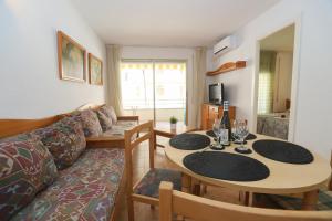 a living room with a table and a couch at COSTA DAURADA APARTAMENTS - Colibri Beach in Cambrils