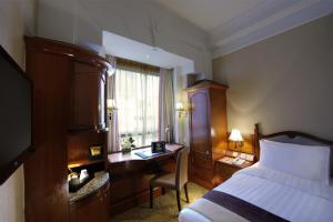 香港的住宿－銅鑼灣利景酒店，配有一张床、一张书桌和一扇窗户的酒店客房
