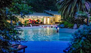 a group of people in a swimming pool at a resort at Taupo Debretts Spa Resort in Taupo