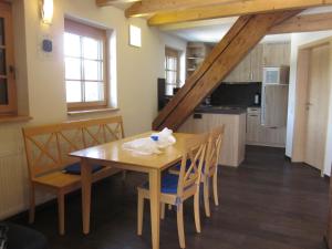 a kitchen and dining room with a table and chairs at Gasthaus Kalte Herberge in Vöhrenbach