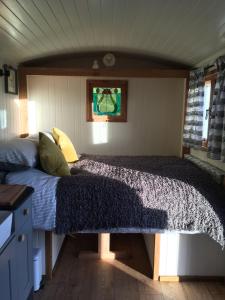 a bedroom with a bed in a small room at Shepherds Hut in the Hills - Nr. Mold in Nannerch