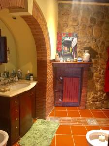 a bathroom with a sink and a red door at la baita in Salerno