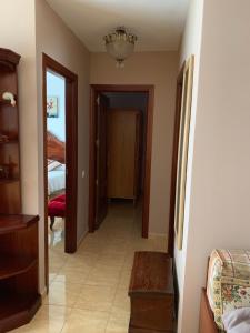 a hallway leading to a bedroom with a chandelier at Casa Carmelito in Moya