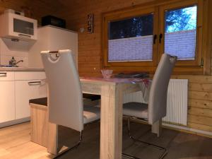 a kitchen with a table and two chairs at Ferienhaus Natura in Neuruppin