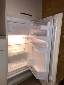 an empty refrigerator with its door open in a kitchen at Ferienhaus Natura in Neuruppin