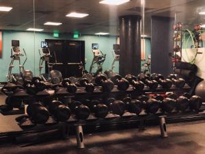 a gym filled with lots of dumbbells and other equipment at The Marker San Francisco in San Francisco