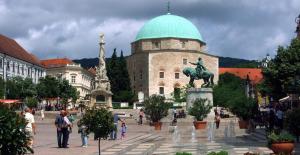 a building with a green dome on top of a fountain at St. Péter Apartman in Pécs