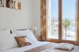 a bedroom with a bed and a large window at New luxury apartment Nives on seaside in Split