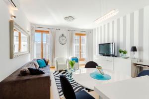 a living room with a couch and a table at New luxury apartment Nives on seaside in Split