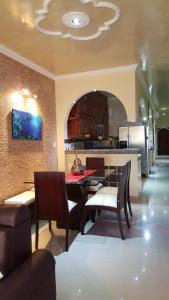 a kitchen with a table and chairs and a dining room at The Clover Home in Palmira