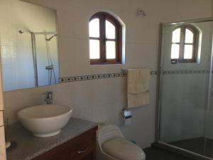 a bathroom with a sink and a shower at Cabañas Terra Pocuro in Los Andes