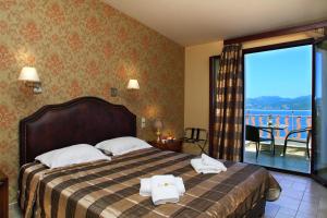Postel nebo postele na pokoji v ubytování Hotel Tesoro