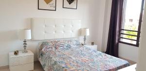 a bedroom with a bed and two lamps and a window at Balcon Del Mar Luxury Suite in Costa Del Silencio +31 photos