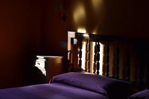 A bed or beds in a room at La Corte del Rondiellu 1