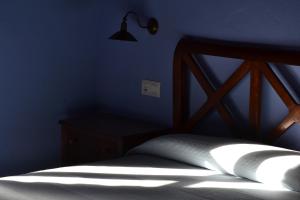 A bed or beds in a room at La Corte del Rondiellu 1