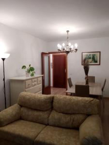 a living room with a couch and a table at NUEVA VIVIENDA/APARTAMENTO COMPLETO EN SEVILLA in Seville