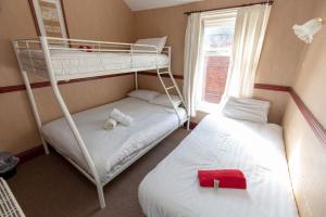 a bedroom with two bunk beds and a window at The Riviera Hotel in Blackpool