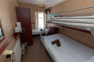 a small room with two bunk beds in it at The Riviera Hotel in Blackpool