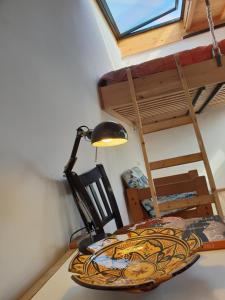 a room with a table and a lamp and a bunk bed at The Rooftop in Essaouira