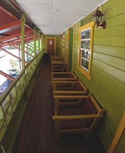 
a row of wooden benches in a room at Hotel Maritza in Puerto Viejo
