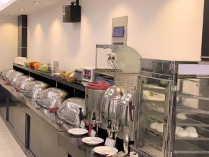 a kitchen with a counter in a kitchen at Shanghai Joyful Star Hotel-Free shuttle bus to Pudong Airport and Disney in Shanghai