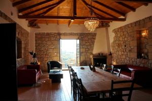 a dining room with a large wooden table and chairs at SPITI MAS in Proástion +38 photos