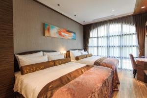 Postel nebo postele na pokoji v ubytování Grand Cosmos Resort Ruisui Hualien