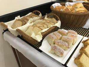 a display of bread and pastries on a table at Paissandú Palace Hotel - Próximo às ruas 25 de Março, Sta Ifigênia e regiões do Brás e Bom Retiro in São Paulo