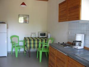 a kitchen with a table with chairs and a microwave at NIKOS in Kakovatos