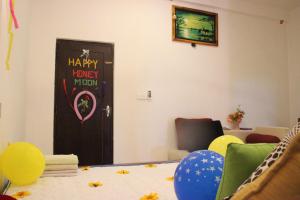 a room with a happy honeyworth door and a table with balloons at Miheen Hotel & Resort - Anuradhapura in Mihintale