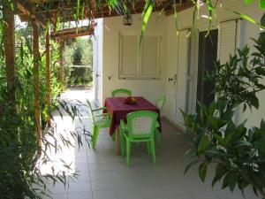 a green table and chairs on a patio at NIKOS in Kakovatos
