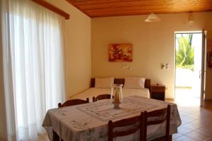 a room with a table and a bed and a bedroom at ORFANOS 3 in Armenoí