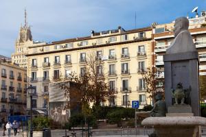 a large building with a statue in front of it at Hostal Zamora in Madrid