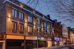 a brick building with a sign on it on a street at Putney Hotel in London