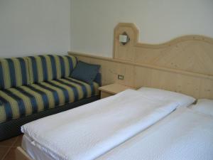 カヴェダーゴにあるBellavista B&Bのベッドとソファ付きのホテルルーム