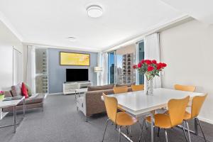 a living room with a white table and chairs at Beach Stay - Ocean & Riverview resort Chevron Renaissance central Surfers Paradise in Gold Coast