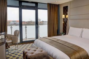 a hotel room with a bed and a large window at Putney Hotel; BW Signature Collection in London